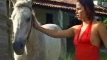 Red dress hottie fucks a horse in front of its owner