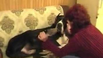 Amateur woman gets busy with the dog's dick while being filmed