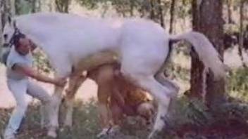 The wife moans of lust with the horse cock in her mouth
