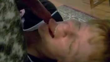 Amateur older woman chokes on the dog's penis while performing oral on it