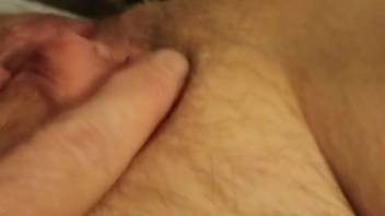 Lady fingers her clitoris as the dog tongues her vagina