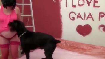 Dark-haired woman demonstrates messy oral expertise on a rigid canine shaft
