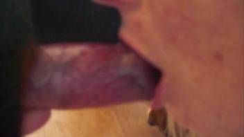 Fair-haired woman sucking a canine's dick deeply on video