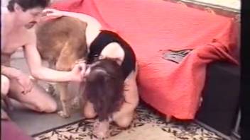 Naked woman experiences a big dog's cock in her furry pussy